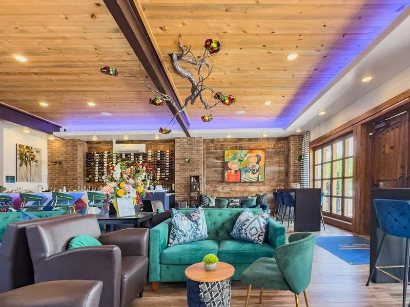 Vibrant jewel colors and brick decorate the wine and spirits tasting room.