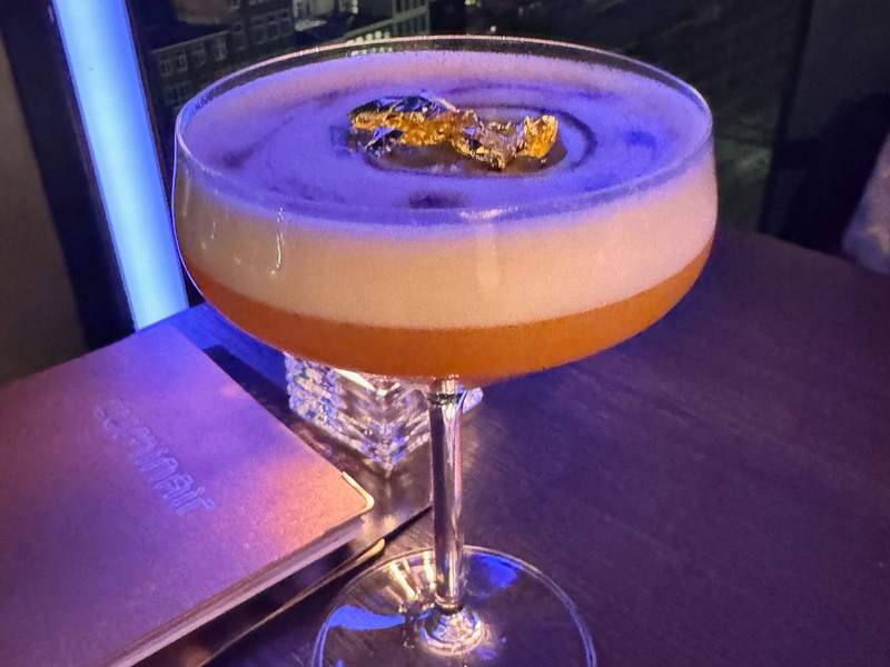 Glam martini topped with gold leaf in the cocktail at DoubleTree Amsterdam Centraal Station rooftop bar LuminAir.