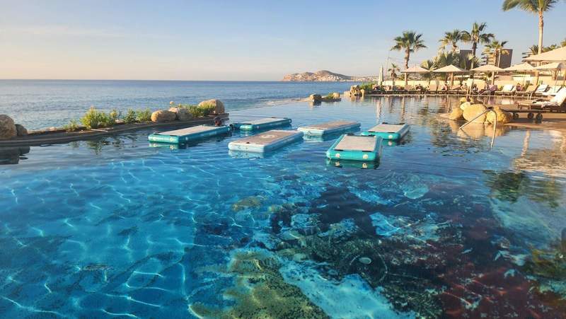 Standup paddleboards floating on an infinity pool.