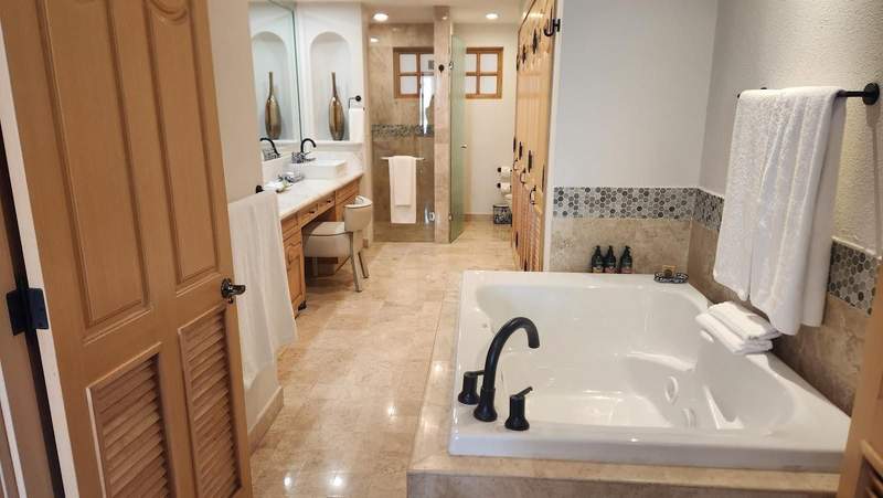 Bathroom with a large jetted tub and vanity.