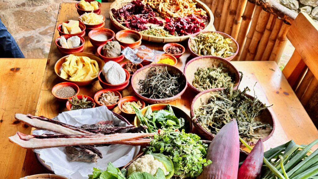 Bowls of food and herbs on a table in Bhutan.