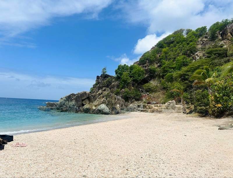 Shell Beach with beautiful sand clear waters and green hilltops with lush trees
