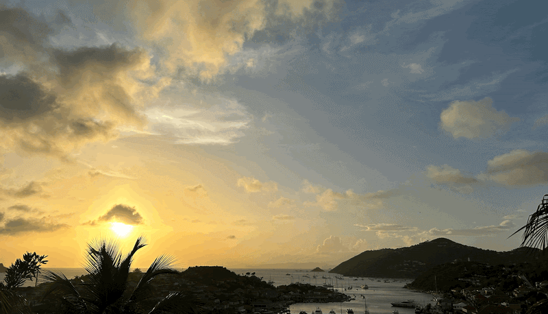 Beautiful sunset dominates the sky setting down with the ocean just below it