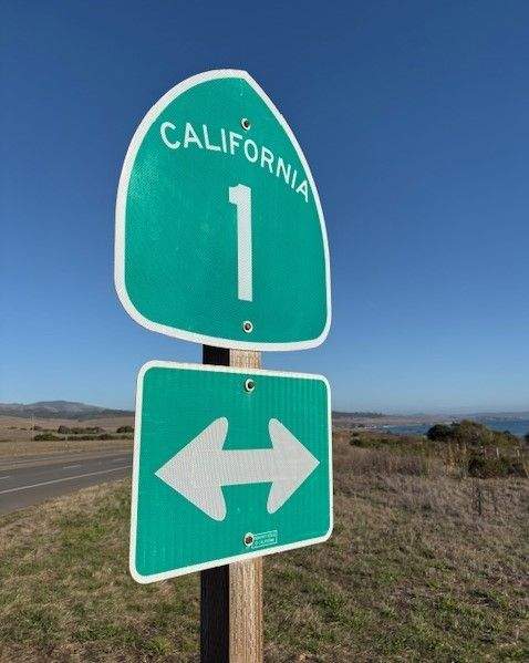 A road trip sign on Highway 1 also called the Pacific Coast Highway