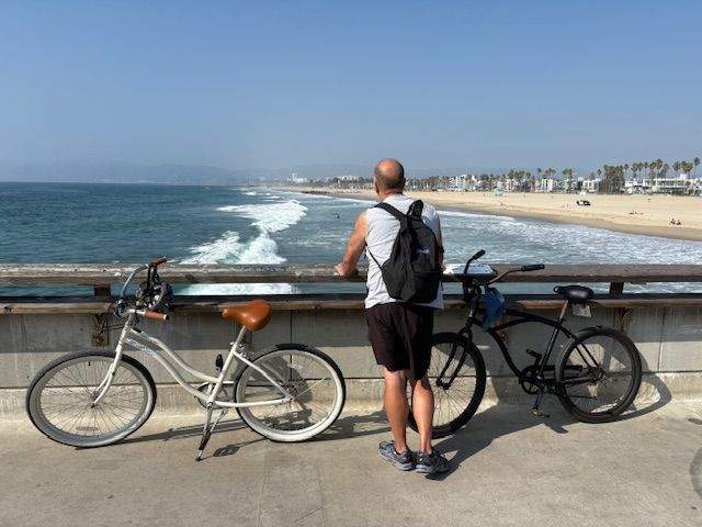 A man watching the surfers on the Pacific Ocean