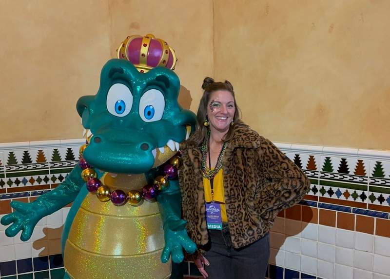 Walkaround meet and greet alligator character with woman at Universal Studios Florida during Mardi Gras
