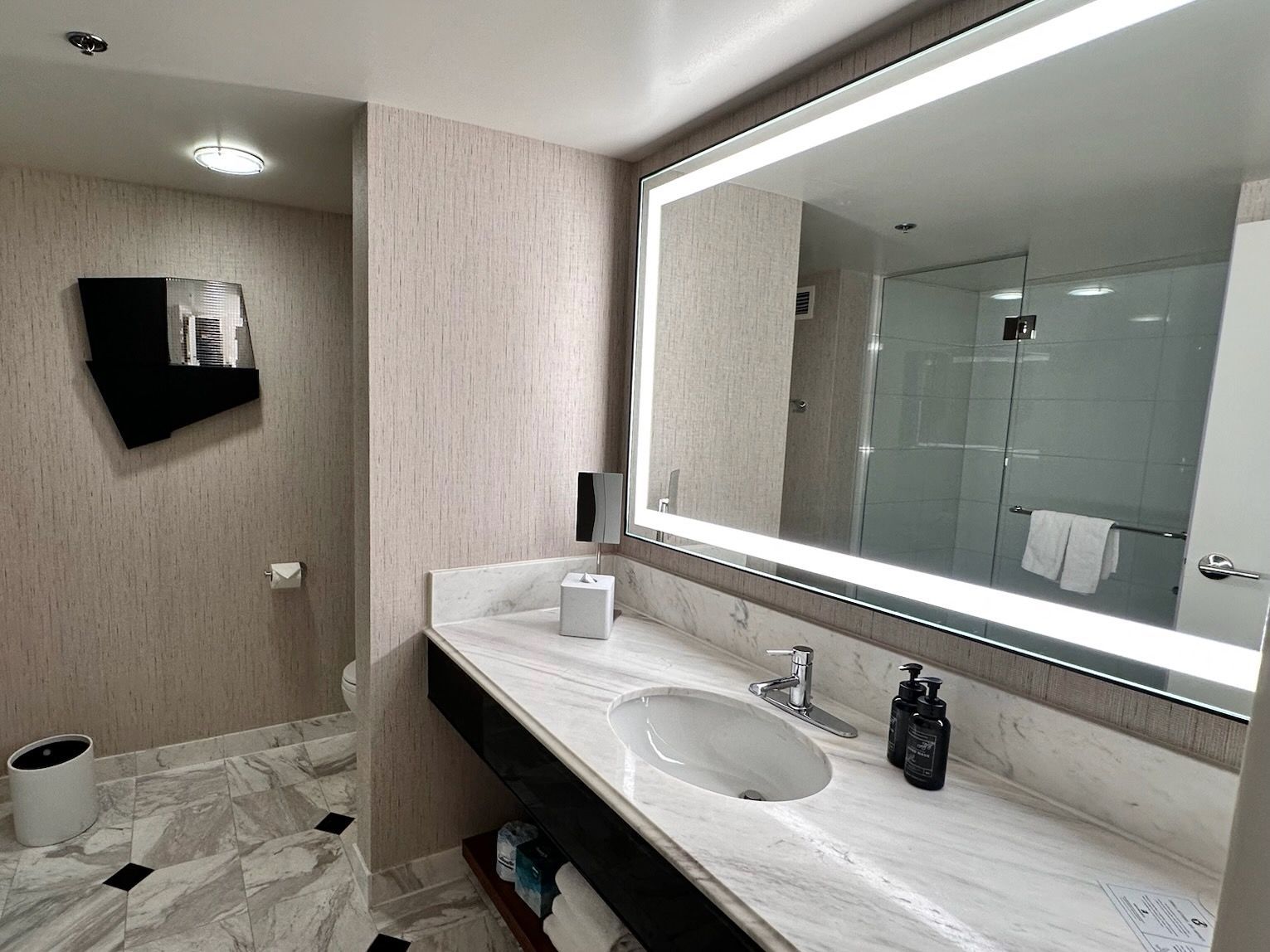 Lighted mirror and lots of storage in updated black and white stylish bathroom at MGM Grand Las Vegas.