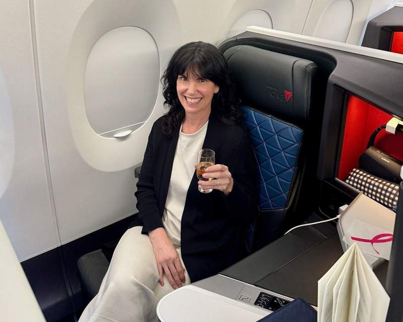 Woman in business class seat on Delta Airlines