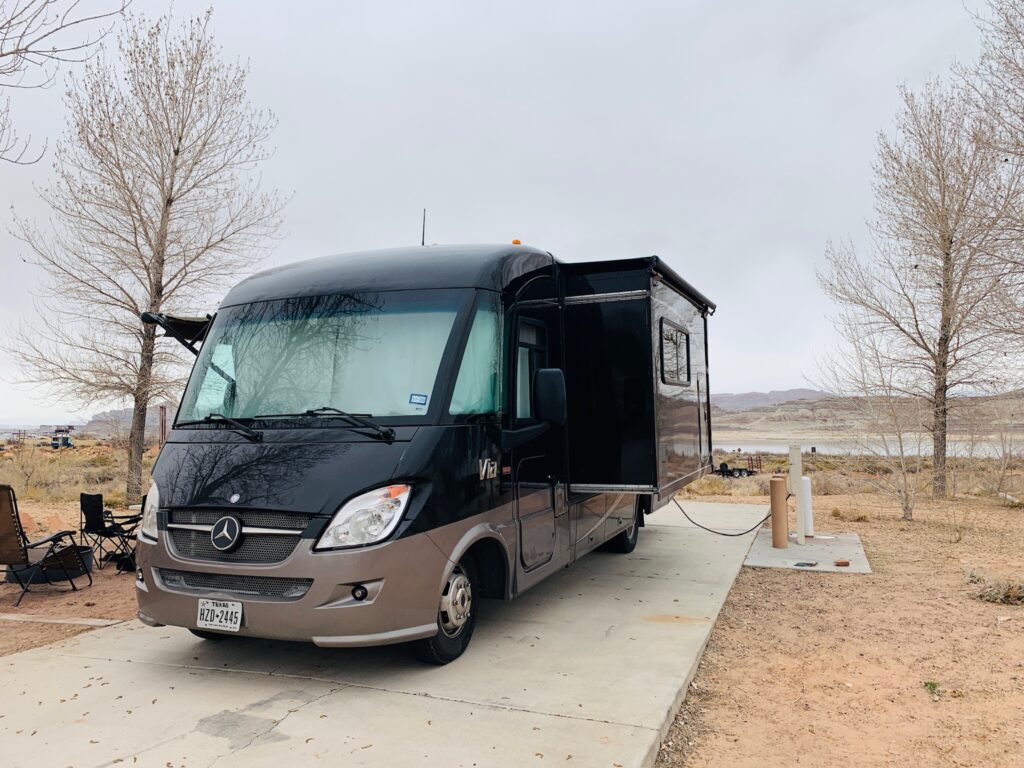 RVshare motorhome on a campsite hooked up to campsite-supplied electricity.