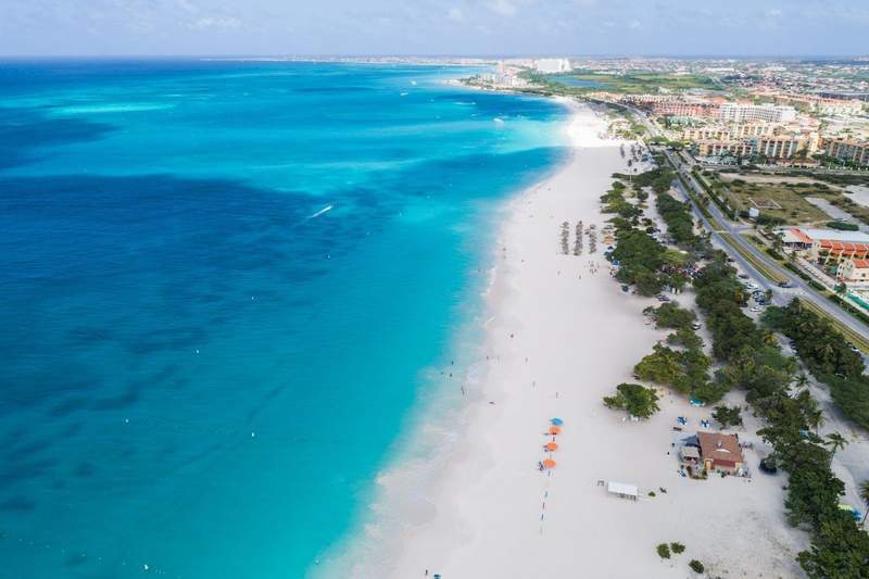 White sand beach and blue water on Aruba island.