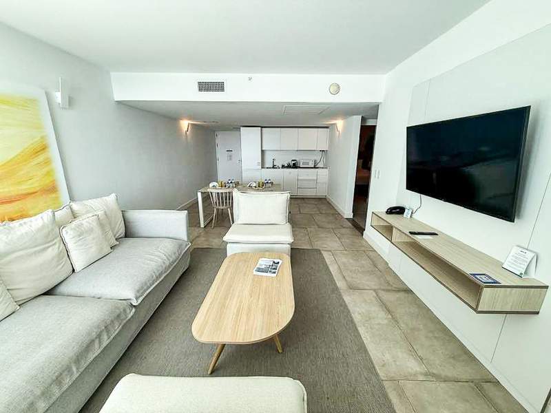 Modern resort living room with white couches and neutral decor.