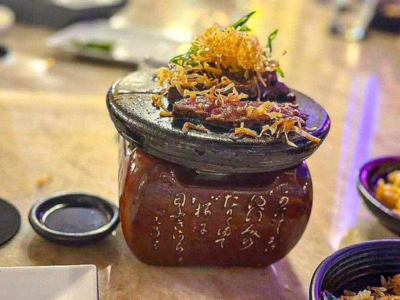 Sizzling meat dish served on hot stone at Azia restaurant Aruba.