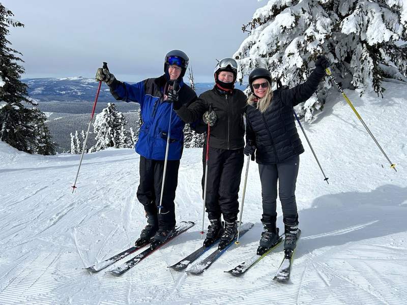 Family skiing at Big White Ski Resort in British Columbia posing for a picture.