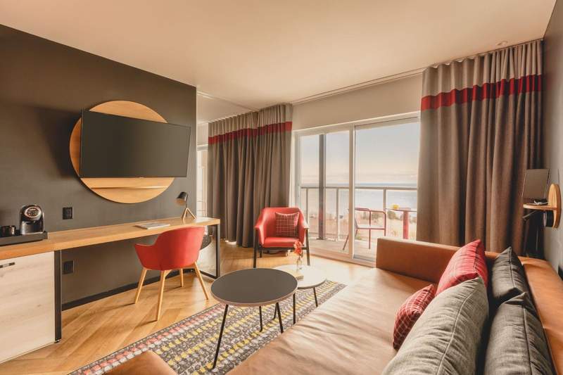 Interior shot of the modern and spacious family rooms at the Club Med Charlevoix with a view of the river from the balcony.