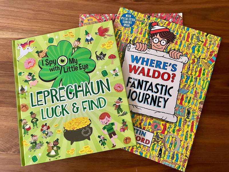 An assortment of seek and find books are on a table.