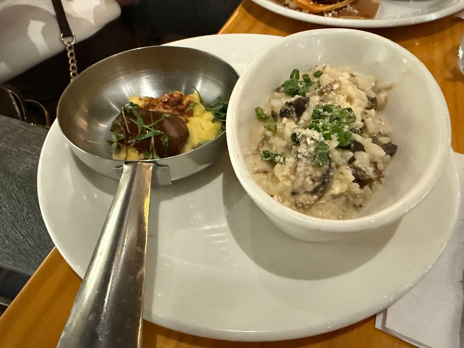 two dishes on a plate, steak on the left and mushroom risotto on the right