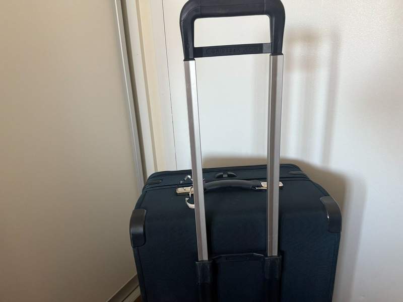 Handle retracted on blue suitcase