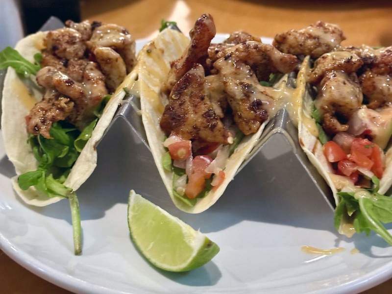 A plate of three alligator tacos