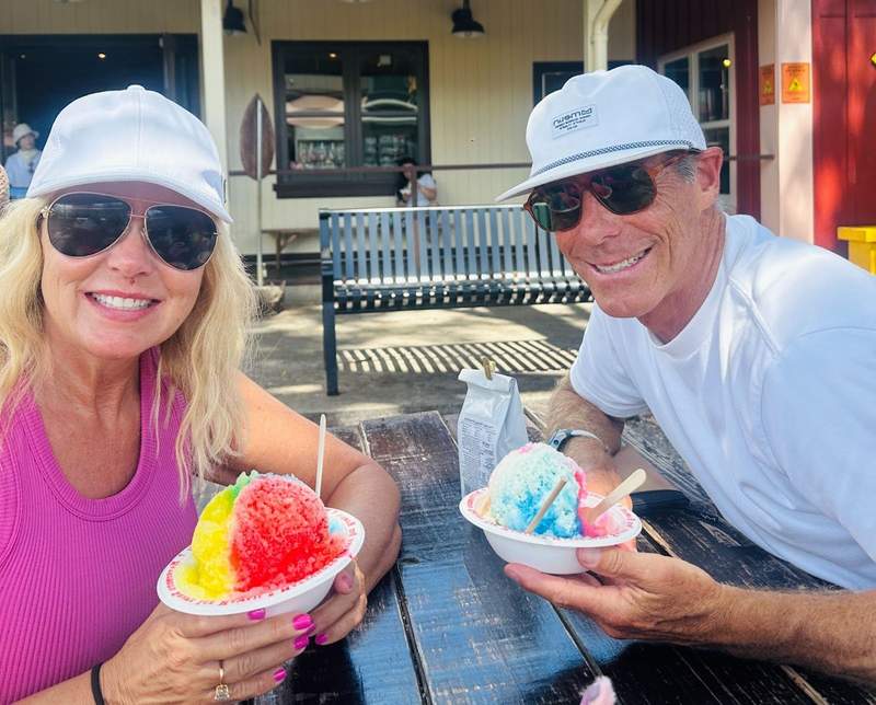 A couple enjoying multi-colored shave ice in Hawaii.