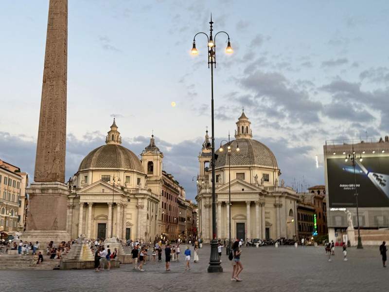 People walking around the Piazza del Popolo or People's Square in Rome Italy.