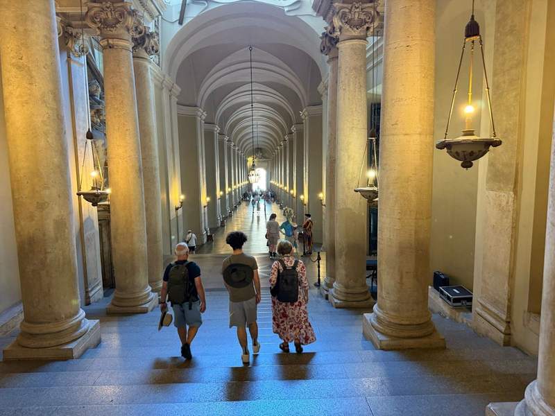 Tourists walking down the Royal Staircase (Scala Regia) inside the Vatican Museums in Rome, Italy.