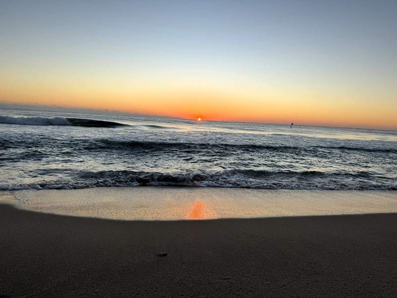 Beach view of sunrise over the Atlantic Ocean from Fort Lauderdale Beach, FL.