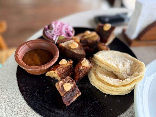 picture of pork belly plated with tortillas