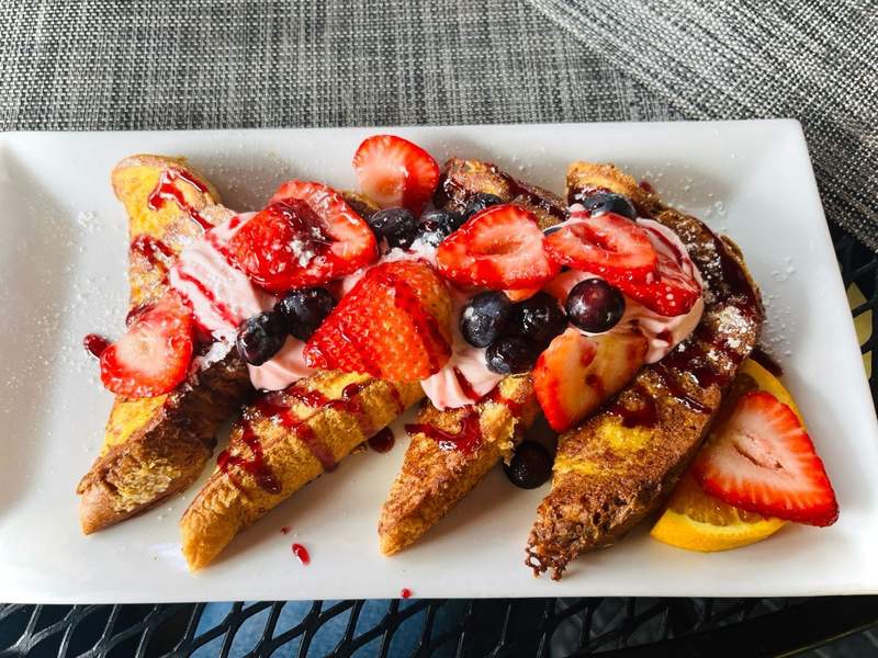 A plate of french toast with fruit