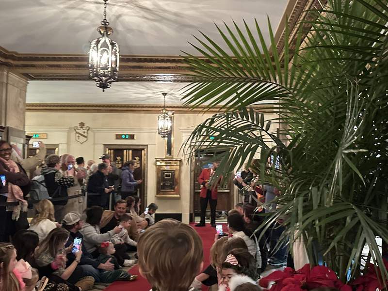 Families gathered in Peabody Memphis lobby for duck march.