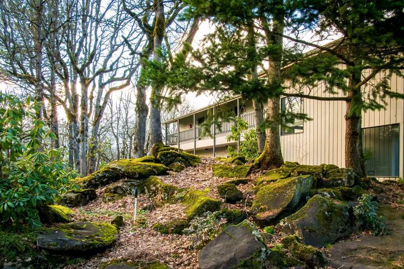 Westcliff Lodge building surrounded by trees and gardens.