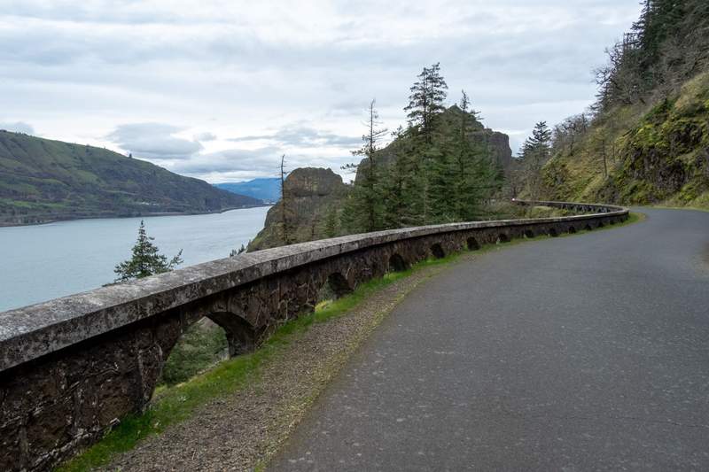 Paved path and stone wall along a river