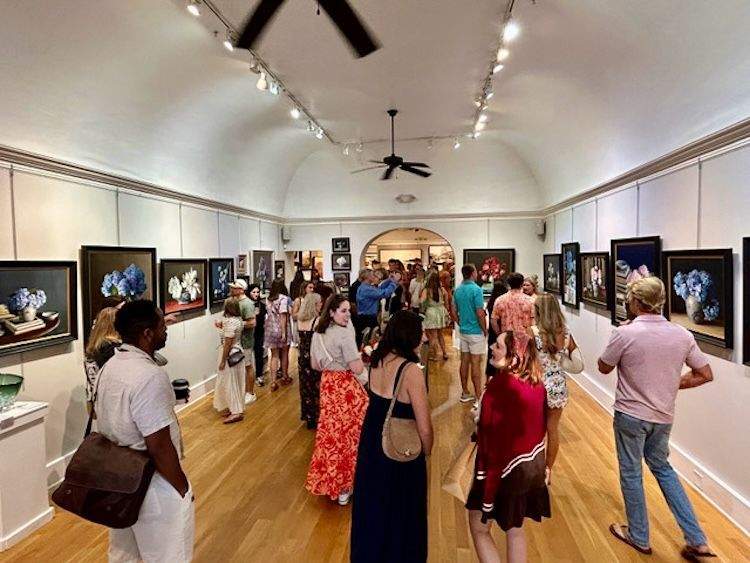 Visitors exploring artwork inside Principle Gallery during First Friday Art Walk