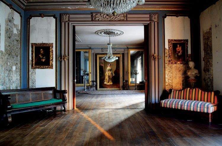 Aiken-Rhett House interior with period furniture, artwork, and chandelier.