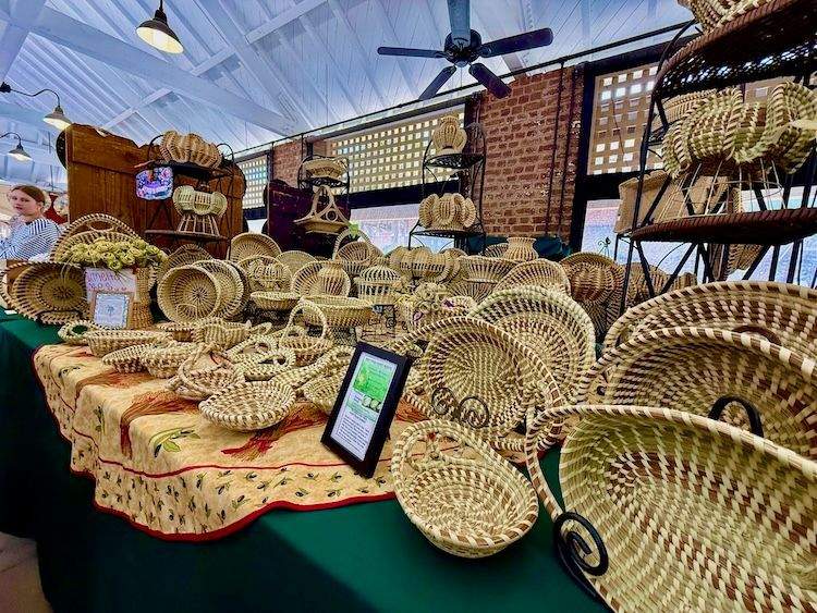 Sweetgrass baskets displayed on a green-draped table at Charleston City Market