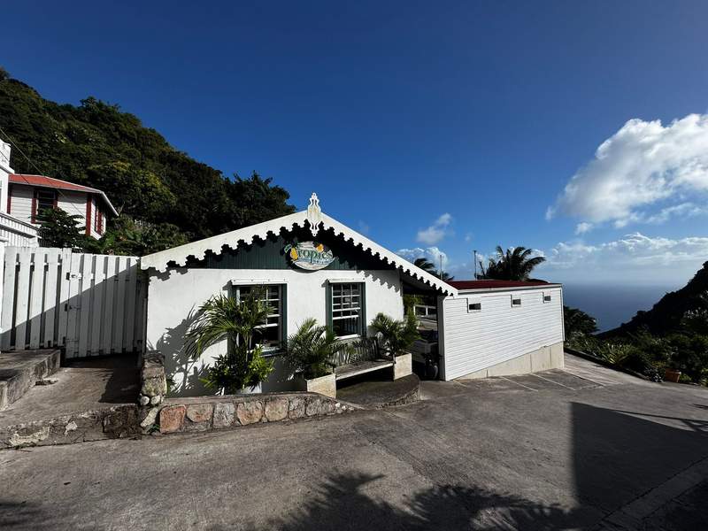 View of Tropics Cafe at Juliana’s Hotel with the ocean in the background.