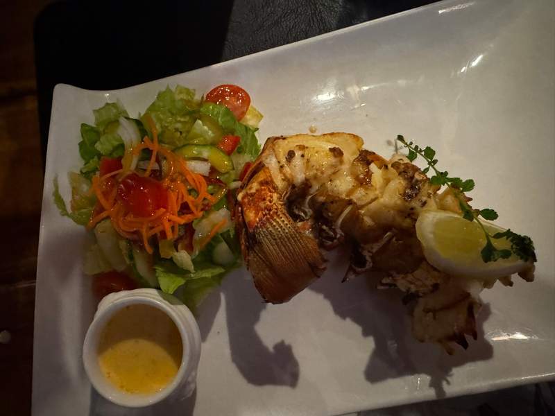 Plate of fresh Saban lobster tail at Brigadoon Restaurant, prepared and ready to eat.