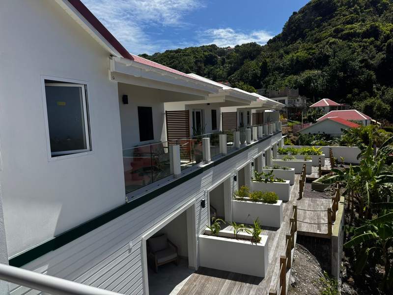 Private terraces at The Scenery Hotel overlooking the island landscape.