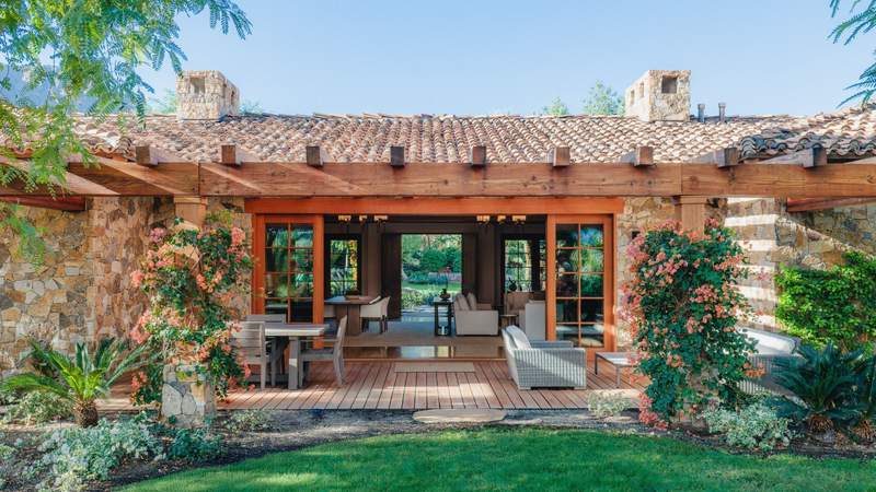 Sensei Retreat Palm Springs outdoor bungalow with doors that open to green gardens and flowers.
