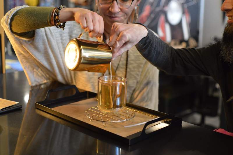 Pouring candle wax into a mold at Mystic Moto in Big Bear.