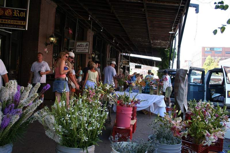 An outdoor flower market on a sunny day greets visitors to Omaha's Old Market district Saturday farmer's market.