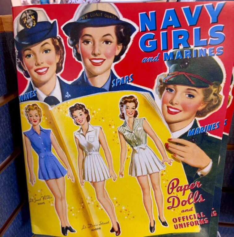 1950s style book of paper dolls pictures three smiling women in lipstick and military uniforms. Also illustrated are three young women in very short pleated skirts and sleeveless blouses.
