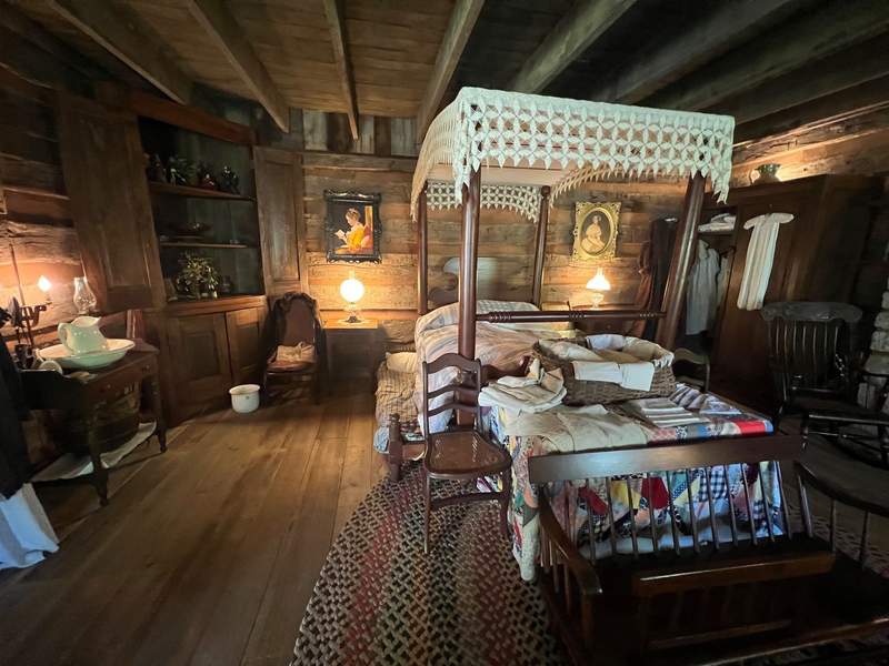 A womans bedroom on display at Historic Collinsville showcasing pioneer life.