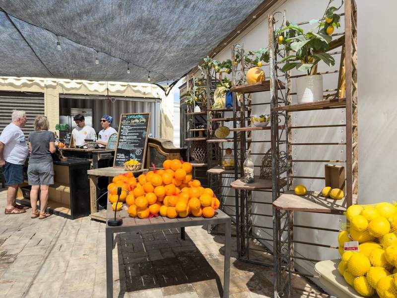 Outdoor dining space at The Lemon Grove with citrus on display and shaded seating.