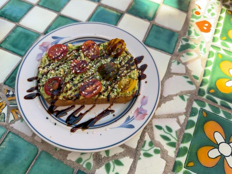 Colorful breakfast plate on a tiled outdoor table at Cafecito in downtown Yuma.