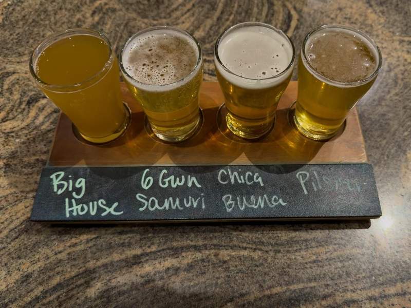 Flight of craft beers served on a wooden paddle at Prison Hill Brewing Company in Yuma.