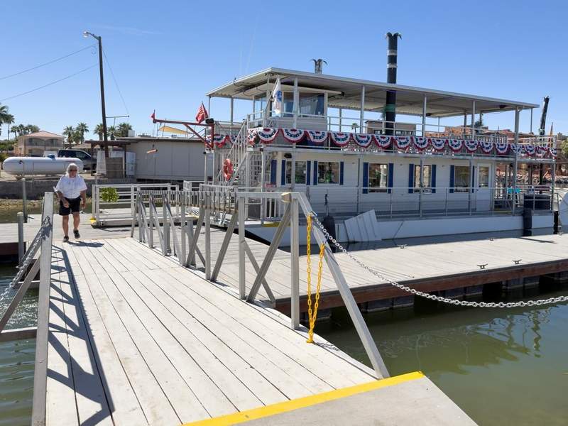 Paddlewheel tour boat at the dock at Martinez Lake with a gangway leading to the boat.