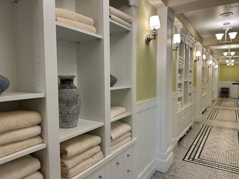 A hallway with towels stacked along the side.