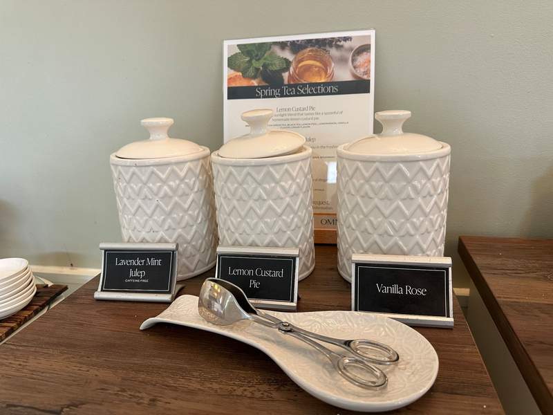 White Canisters with a set of tongs in front. 
