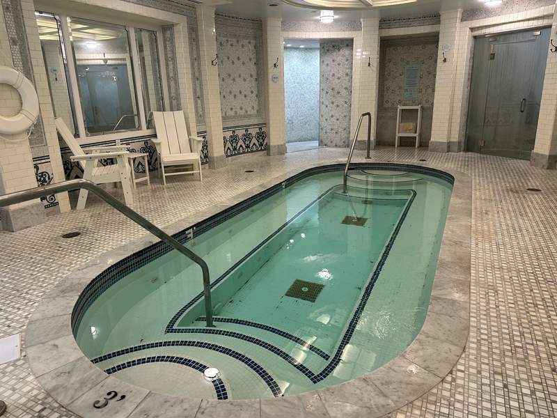A large oblong whirlpool with steps on each end.