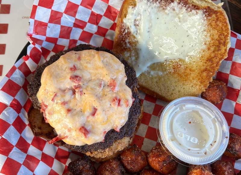 Open-faced burger with pimento cheese on top